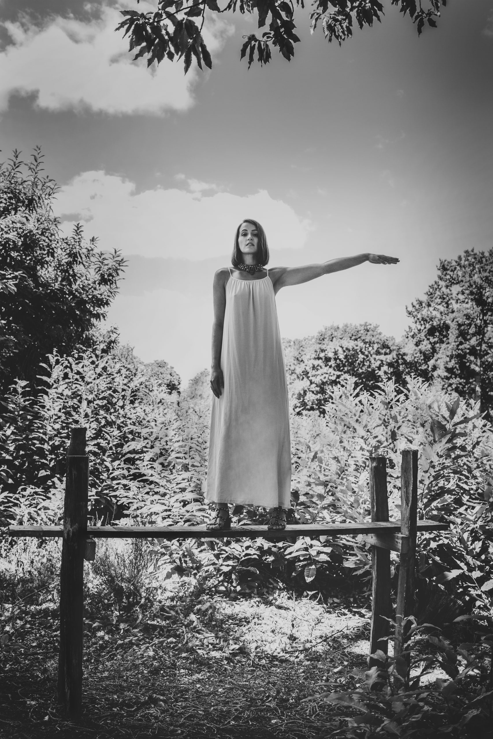 Monochrome image by Tim Copsey of woman standing with arm raised to the side